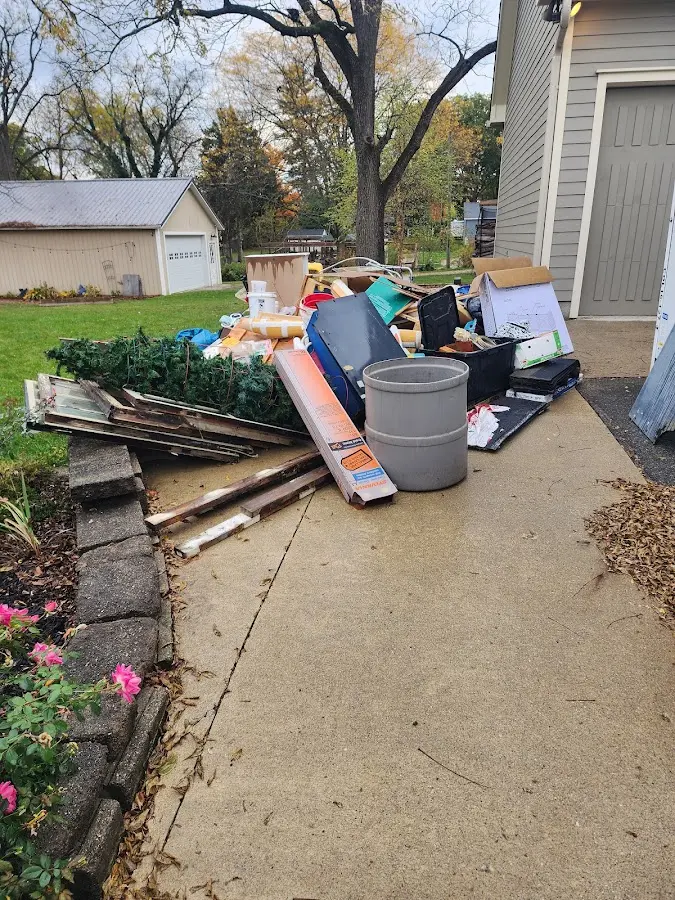 Dumpster being loaded with debris for Commercial Dumpster Rental in The Woodlands